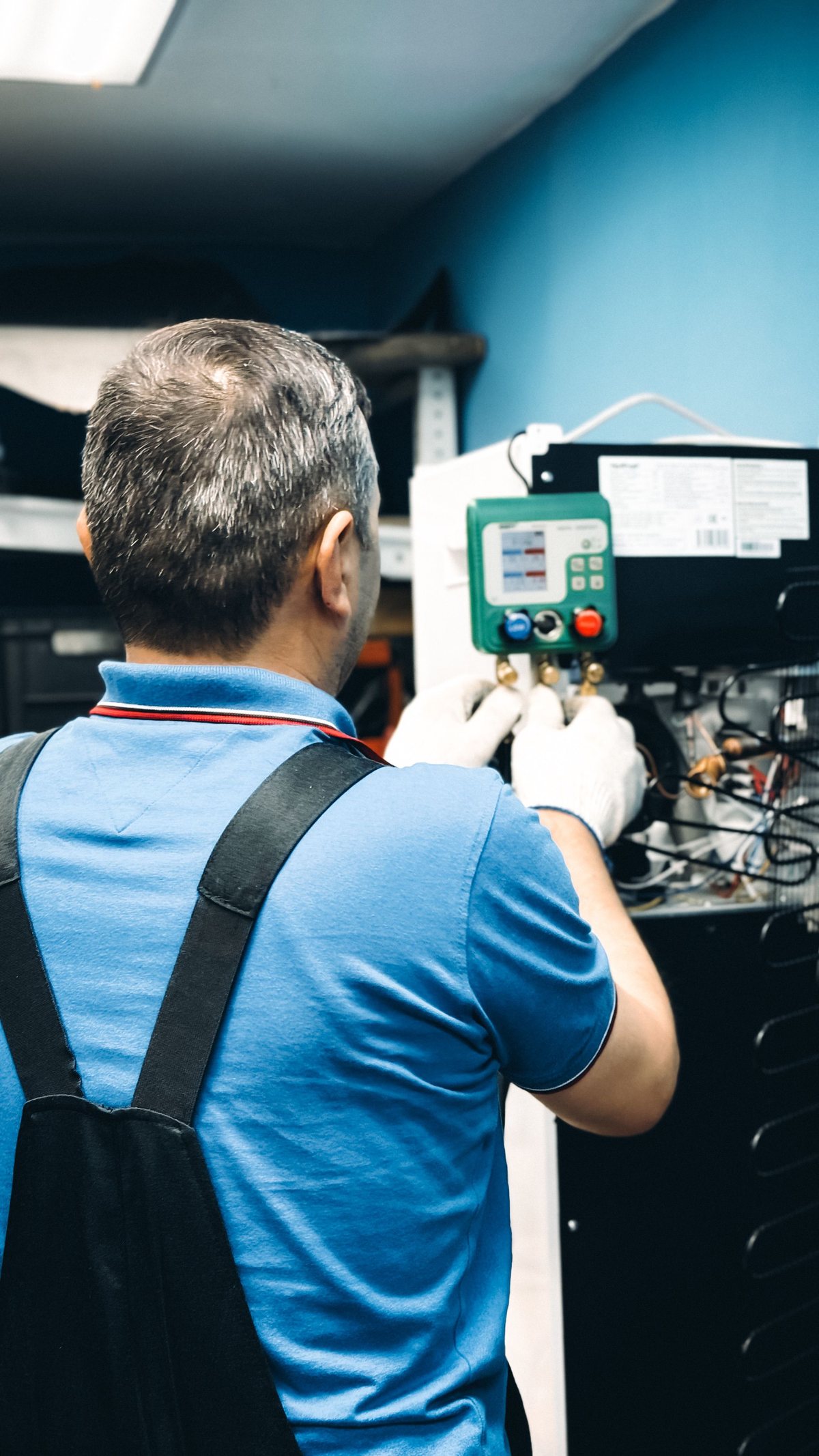 Stock photo of a technician working with HVAC equipment